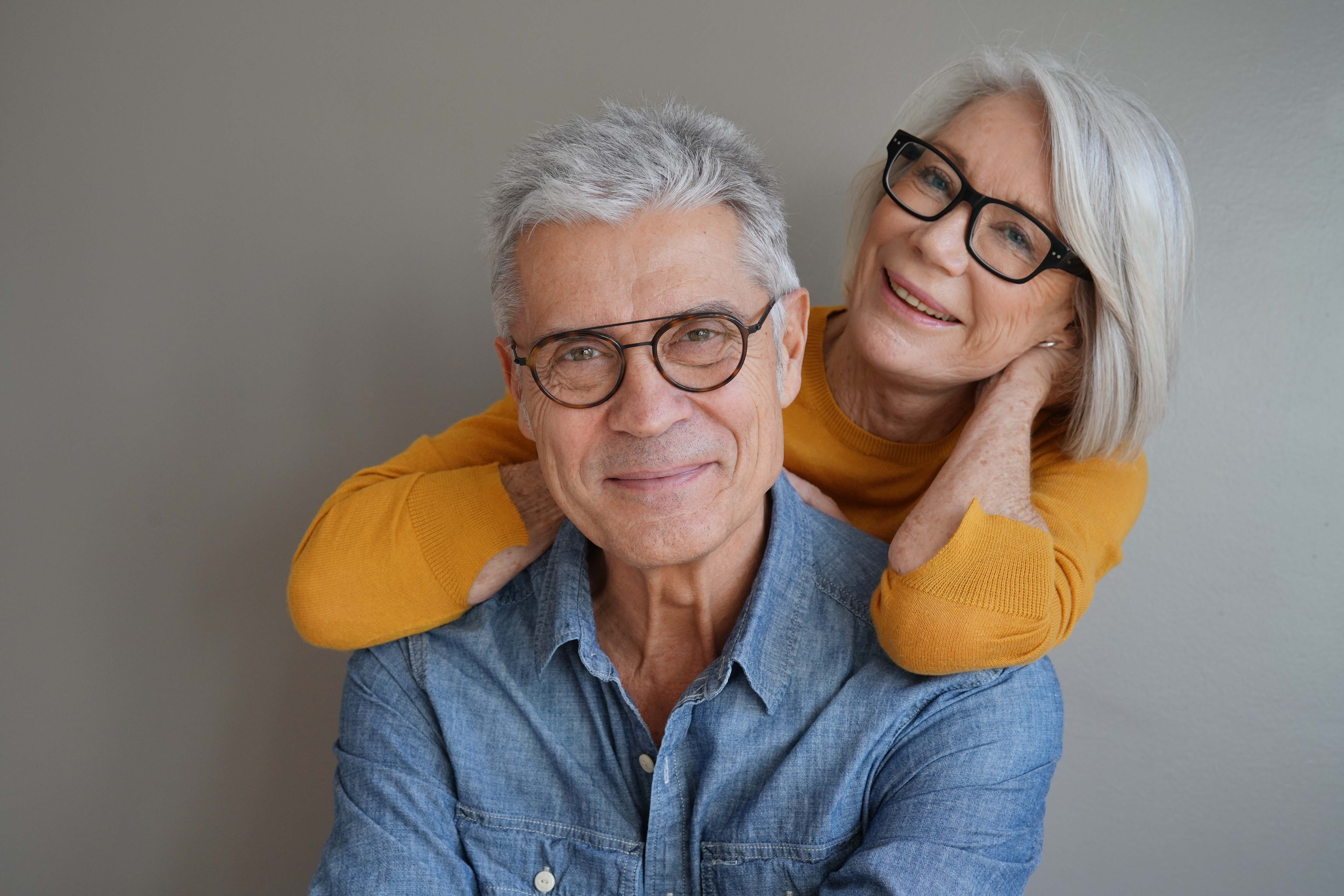 Older couple wearing eyeglasses, illustrating Medicaid vision coverage for adults