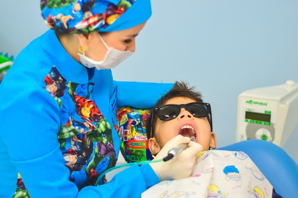 Dentist checking a young patient's teeth during a CareSource Medicaid dental visit